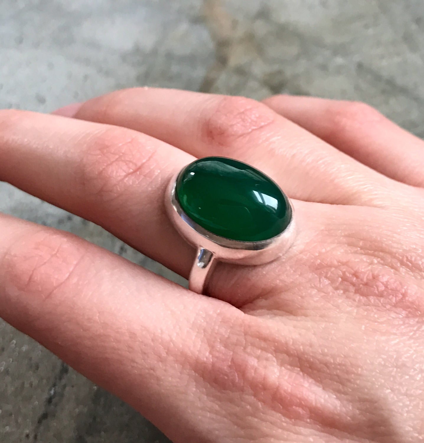 Elegant 925 Sterling Silver ring featuring a bezel-set oval Created Green Emerald, perfect for May birthdays and special occasions.