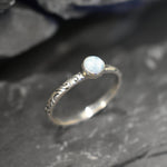 Blue cabochon Larimar ring with scroll details, ideal for coastal fashion or March birthdays.