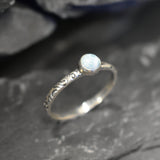 Blue cabochon Larimar ring with scroll details, ideal for coastal fashion or March birthdays.