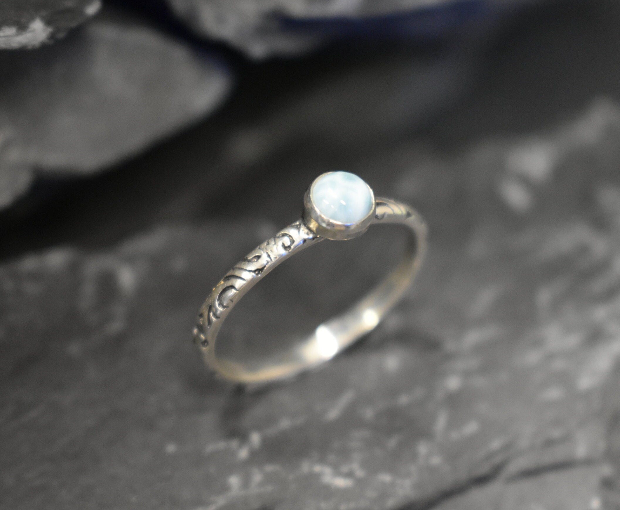 Blue cabochon Larimar ring with scroll details, ideal for coastal fashion or March birthdays.