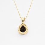 Bold Onyx Pendant Necklace serves as a luxurious statement piece.