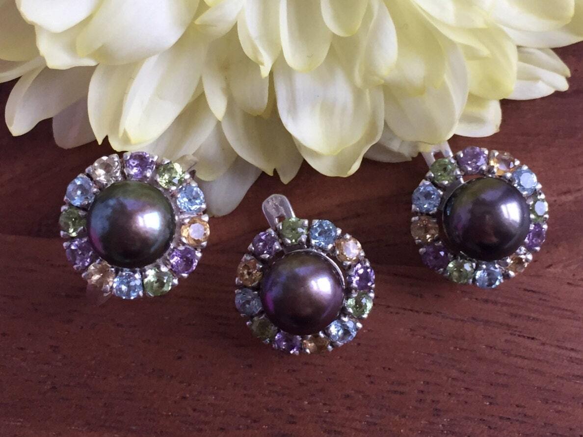 Natural Black Pearl ring encircled by multicolor gemstones, adding luxury to special occasion outfits