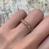 Woman wearing morganite gold ring showing sparkling pink stones on finger