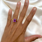 Yellow gold plated ring with real amethyst February birthstone in emerald cut and prong setting. Bold solitaire ring ideal for everyday wear, and personalized gift. Encourages calmness, spiritual growth, and emotional balance. For peace, clarity, intuition