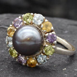 Natural Black Pearl Flower ring with Amethyst, Blue Topaz, Citrine, and Peridot gemstones in a sterling silver halo setting for elegant jewelry lovers