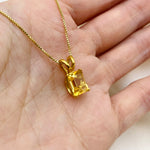 Natural citrine gemstone necklace in 18k gold vermeil resting in open palm - delicate November birthstone jewelry, in emerald cut and prong setting
