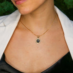 Woman wearing natural onyx pendant necklace paired with white shirt highlighting vintage design