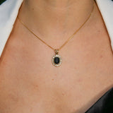Woman wearing natural onyx pendant necklace paired with white shirt highlighting vintage design