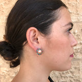 Natural Pearl earrings with multicolored gems complementing a pulled-back hairstyle and simple black top, blending classic jewelry with contemporary style.