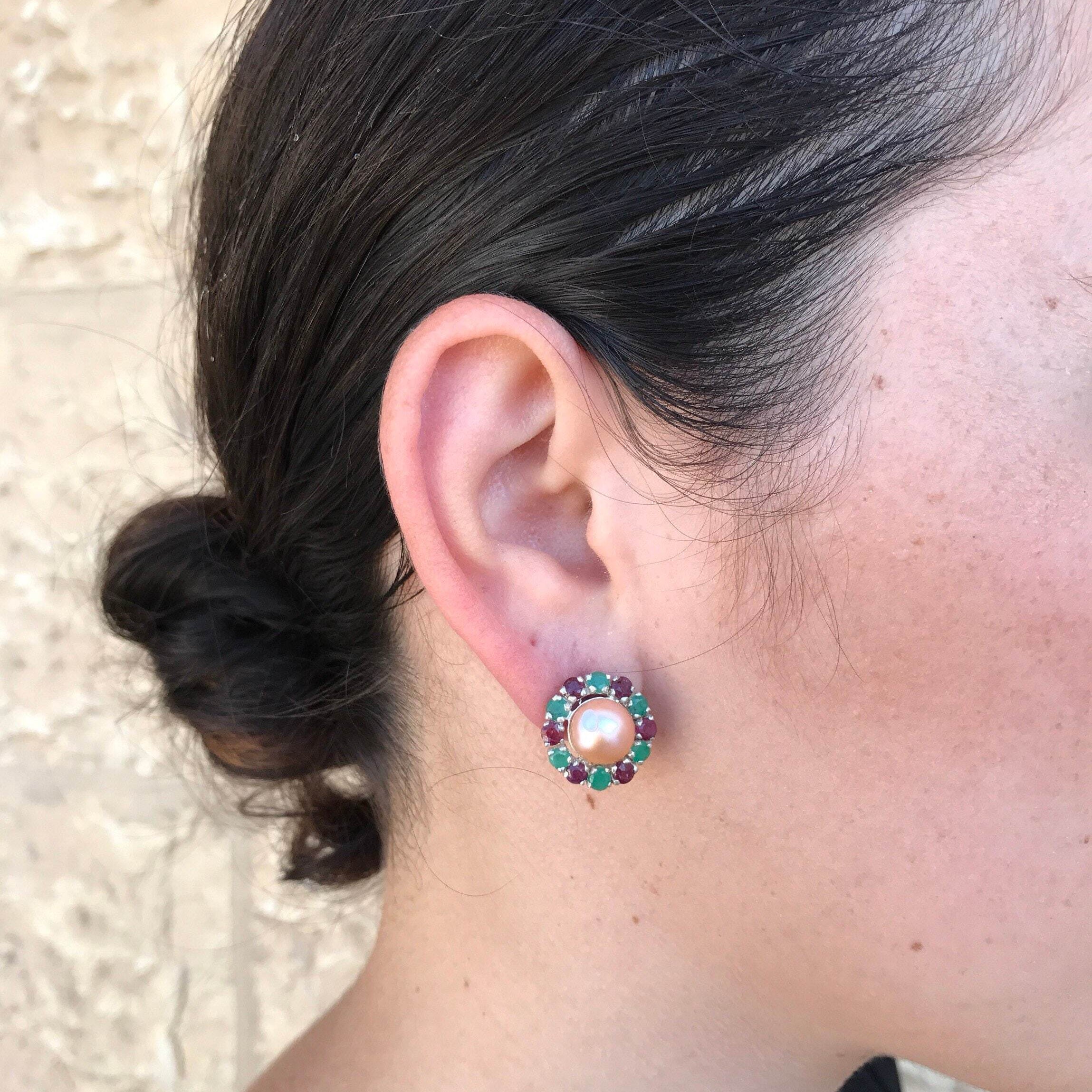 Natural Pearl earrings worn with hair in a sleek bun and a sleeveless black top, perfect for adding elegance to a minimalist outfit for date nights or celebrations.

