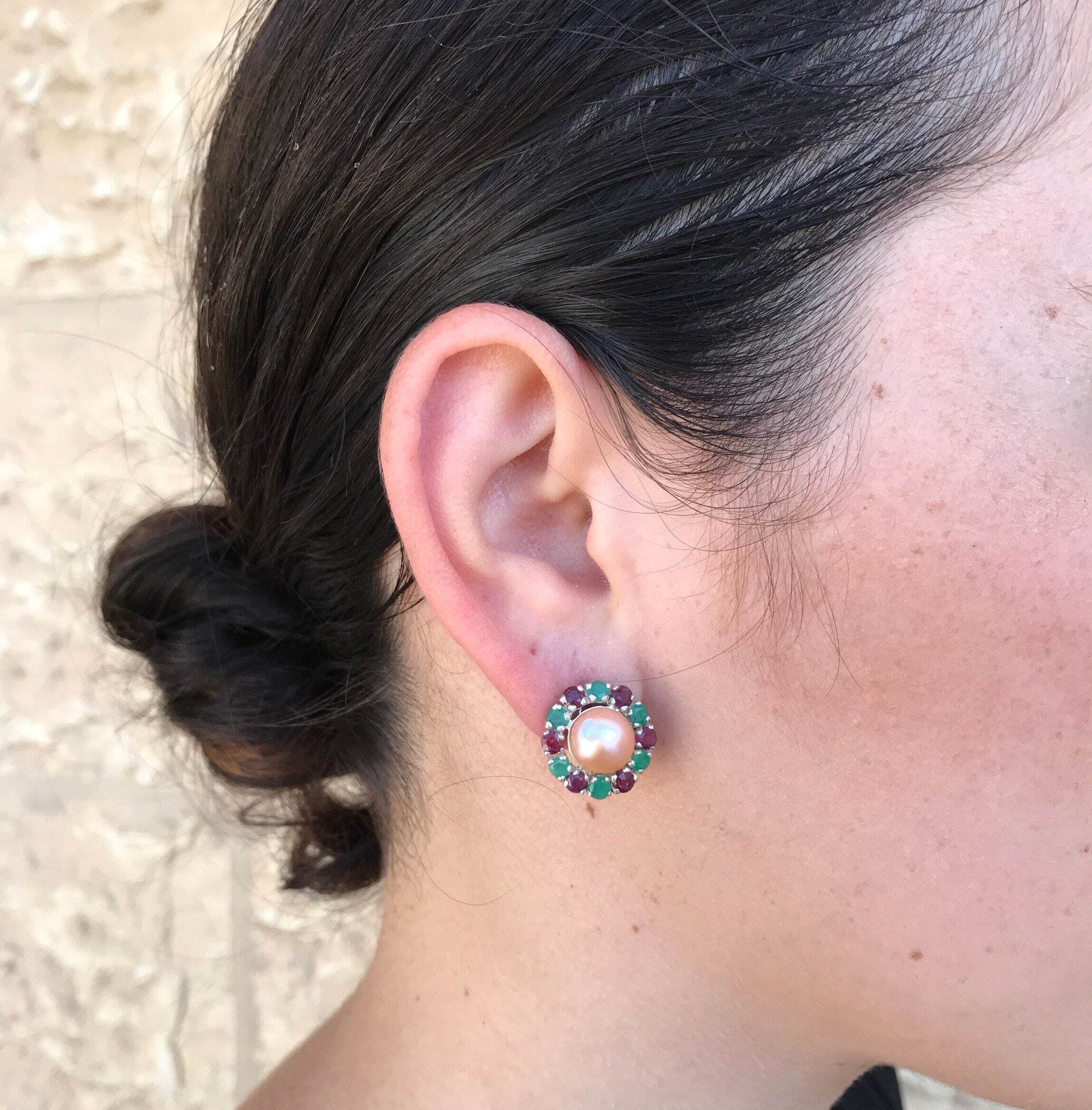 Natural Pearl earrings worn with hair in a sleek bun and a sleeveless black top, perfect for adding elegance to a minimalist outfit for date nights or celebrations.

