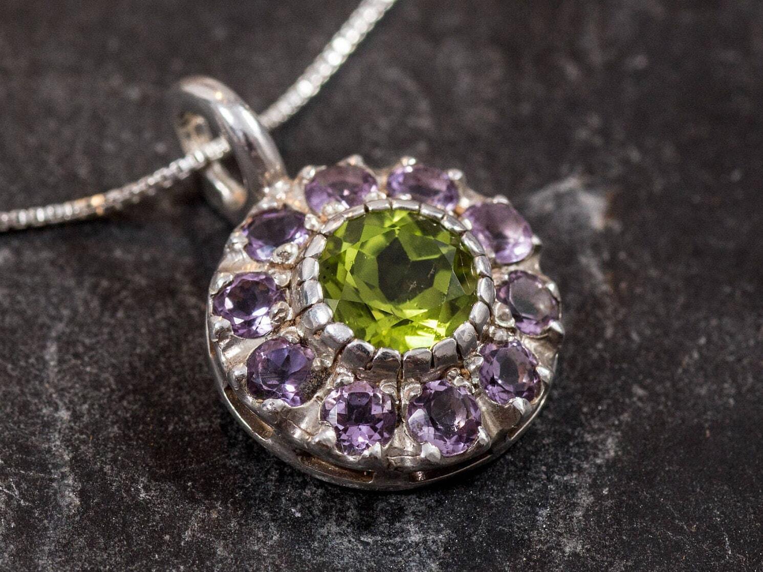 Natural Peridot in a round pendant surrounded by Natural Amethyst stones, exuding a dainty charm for everyday wear, offers emotional clarity and vitality, ideal August birthday gift or meaningful graduation token.