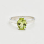 Natural Peridot solitaire ring with oval cut stone, elegant minimalist design perfect for August birthstone gifting and everyday elegance.