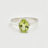 Natural Peridot solitaire ring with oval cut stone, elegant minimalist design perfect for August birthstone gifting and everyday elegance.