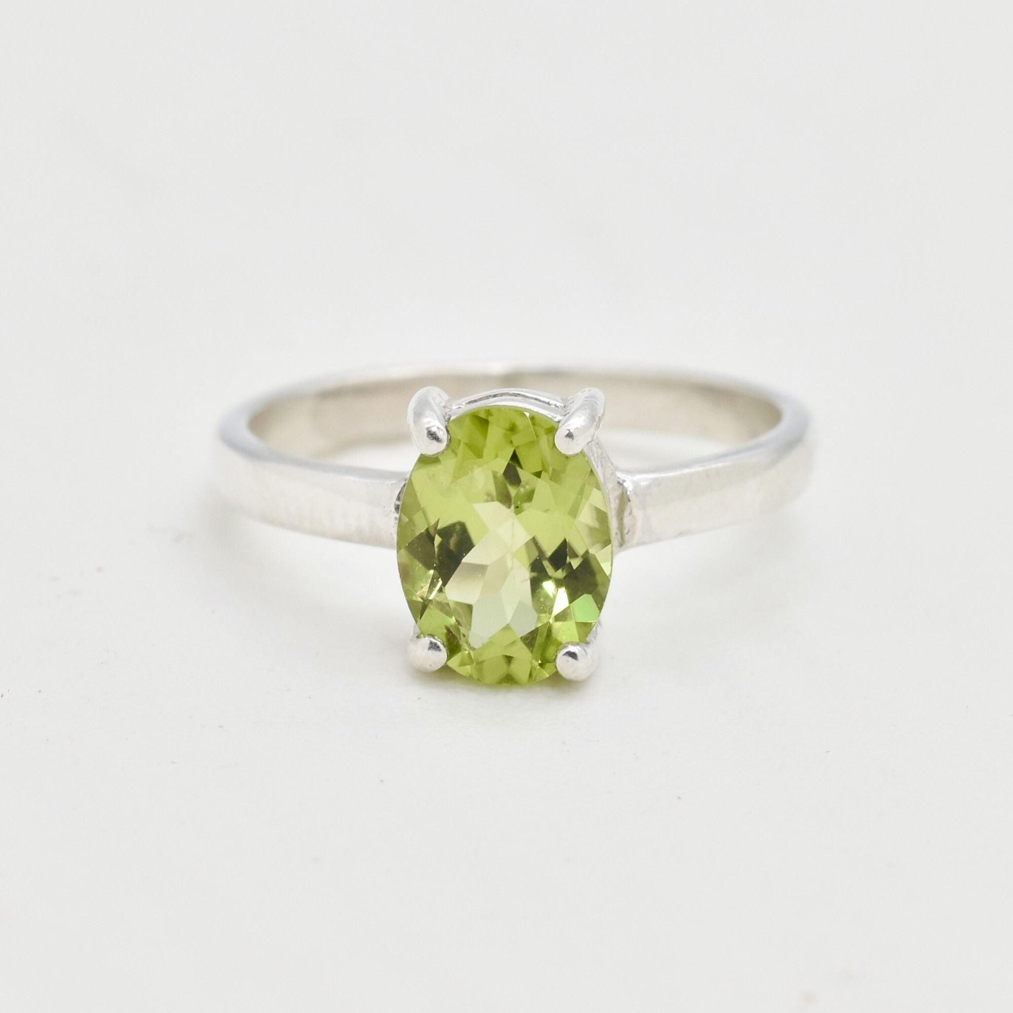 Natural Peridot solitaire ring with oval cut stone, elegant minimalist design perfect for August birthstone gifting and everyday elegance.