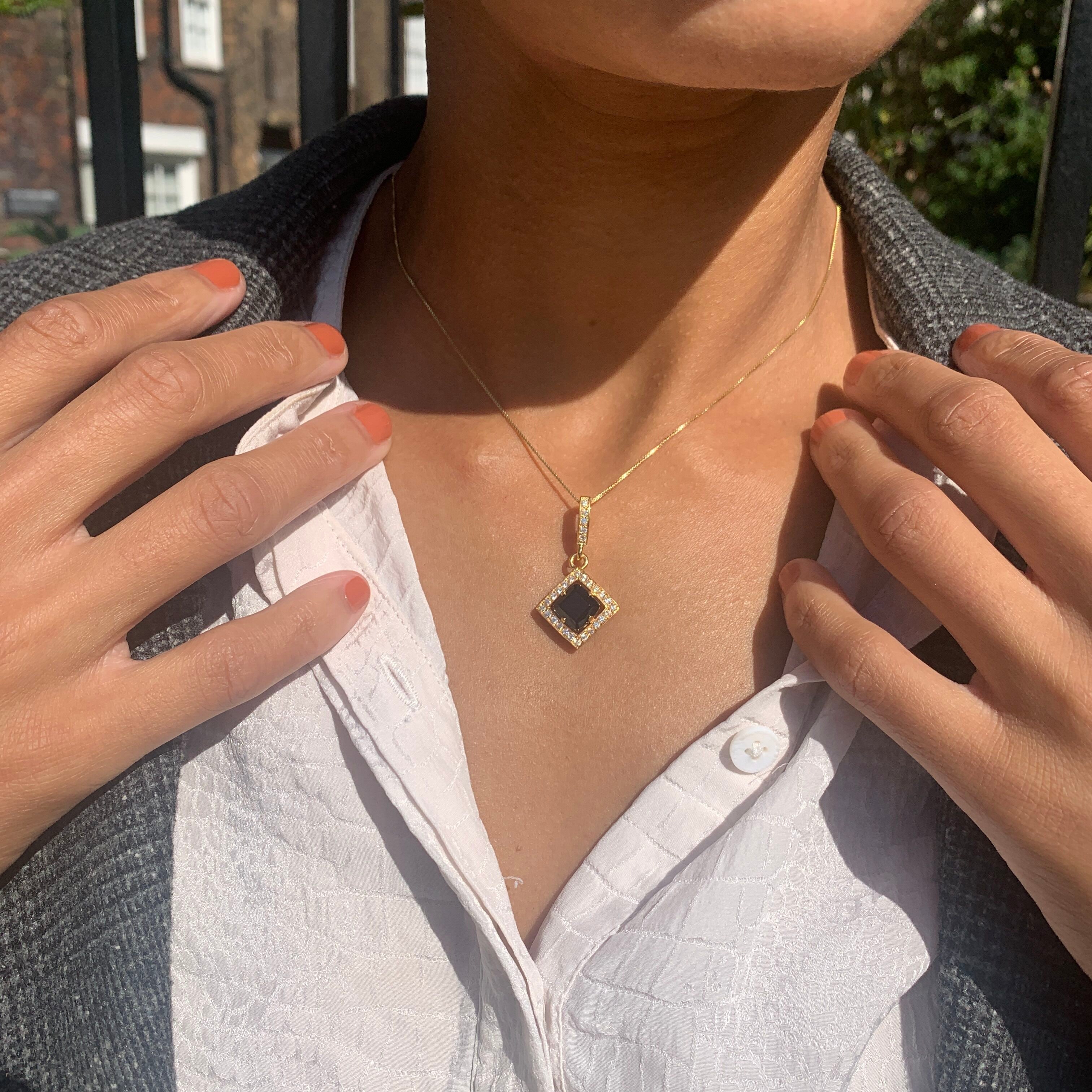 Onyx Necklace with diamond halo makes a unique anniversary gift.

