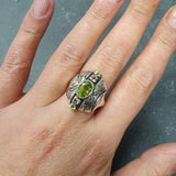 Natural Peridot & Amethyst ring worn on middle finger for casual chic look, pairs well with nude nail polish.