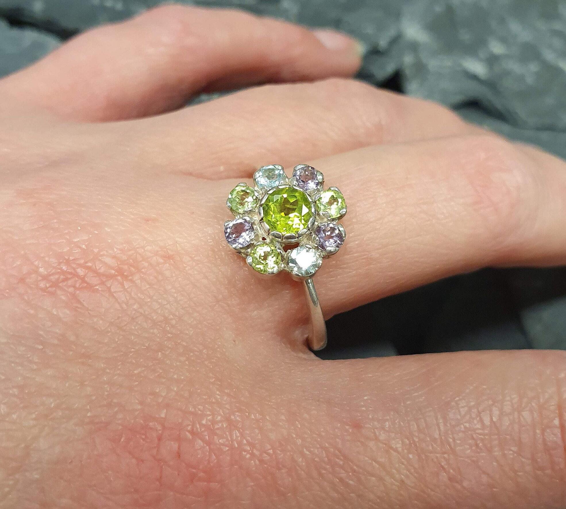 Peridot ring worn on hand with natural nails, creating a fresh and casual gemstone jewelry look.