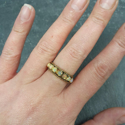 Natural Peridot Band Ring worn on middle finger with clean nude nails, styled for casual chic days and soft wardrobe palettes.