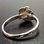 Flower-inspired Sterling ring with Peridot gemstone, invokes harmony and a calm aura, ideal as a mindful keepsake.