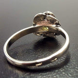 Flower-inspired Sterling ring with Peridot gemstone, invokes harmony and a calm aura, ideal as a mindful keepsake.