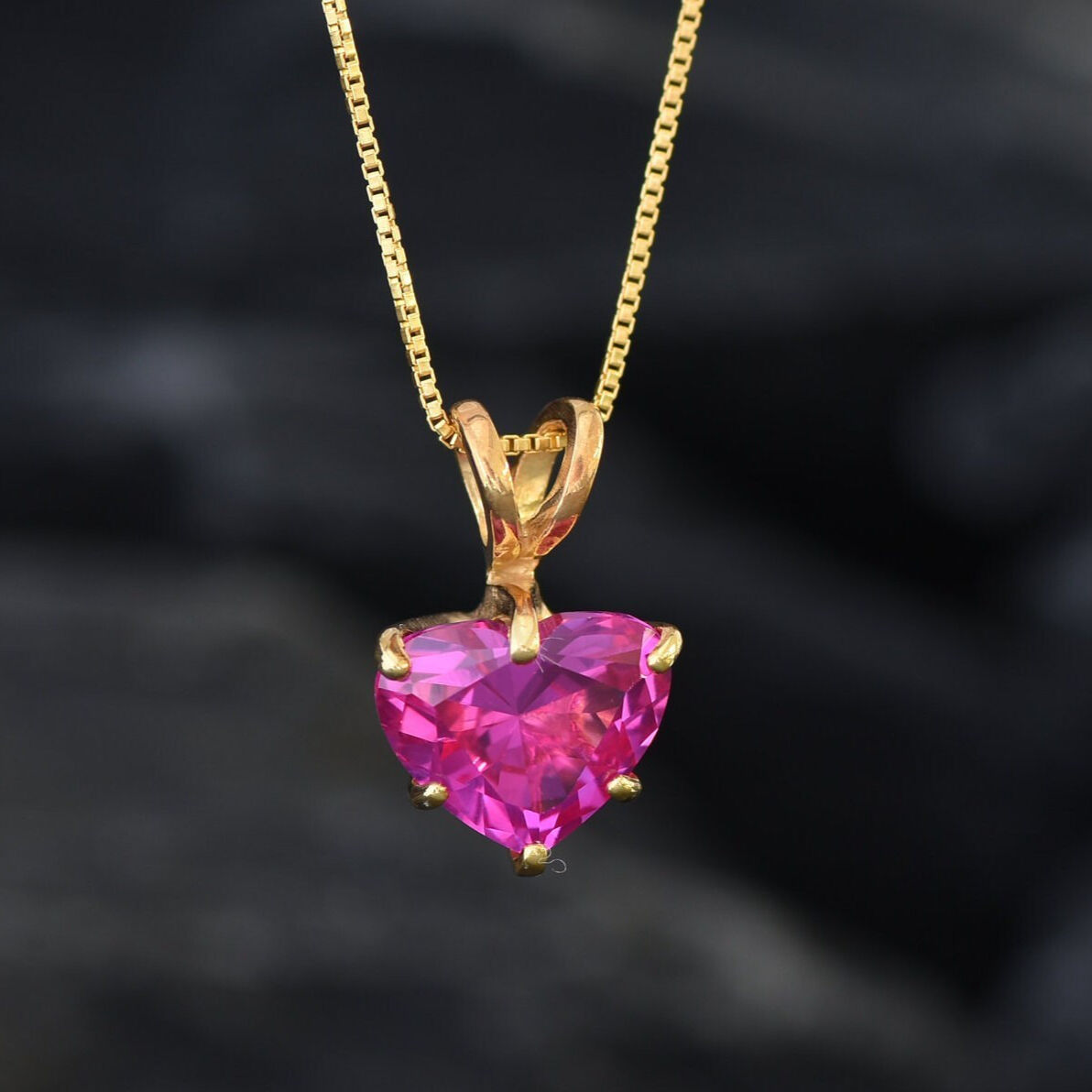 A dazzling Pink Alexandrite gemstone pendant in heart shape paired with an elegant gold chain, symbolizes affection and clarity, best for birthdays and milestones