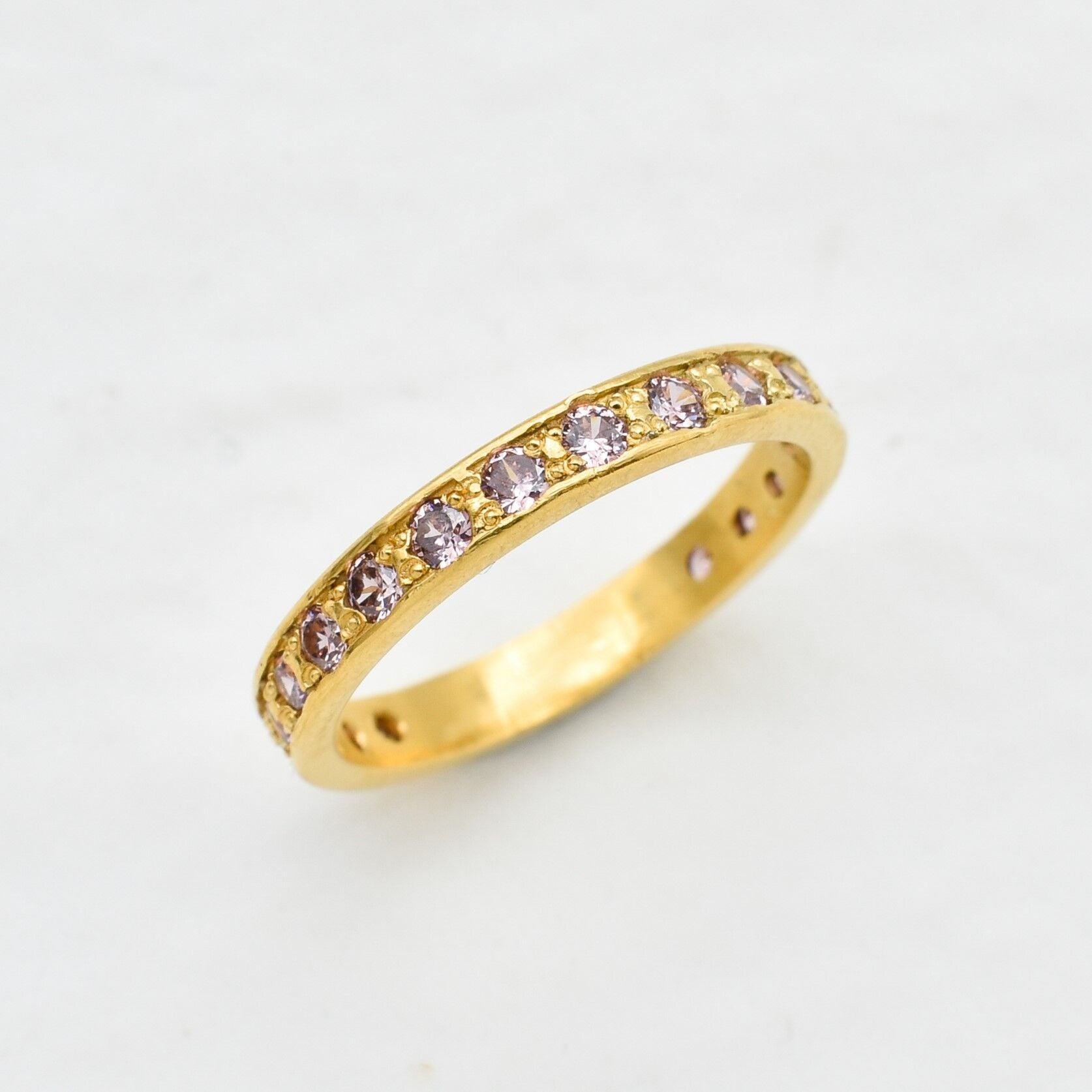 Yellow gold plated ring with morganite gemstones in small round cut. Eternity ring ideal for everyday wear and stacking rings. 