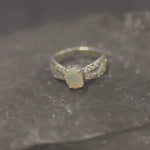 Opal Ring with split shank band and CZ pave setting showing flashes of fire colors, designed as elegant fine jewelry. Known for its emotional healing and creativity benefits, Opal is also the October birthstone and a thoughtful gift for birthdays or anniversaries. Perfect to wear at weddings, romantic dinners, and special evening celebrations.