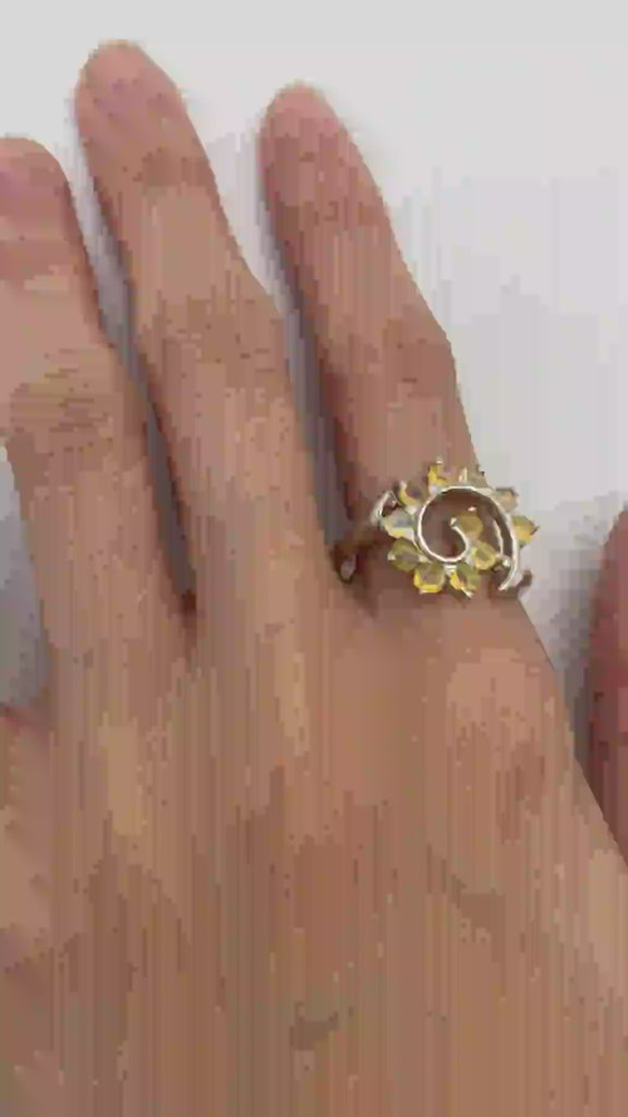 Flower Opal Ring styled on the index finger with natural bare nails, a striking sunburst design that highlights creative energy, meaningful as an October birthstone gift, suitable for casual meetups and festive celebrations.