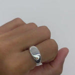 Side angle shot of a solid 925 sterling silver band ring worn on a hand for a natural lifestyle look.