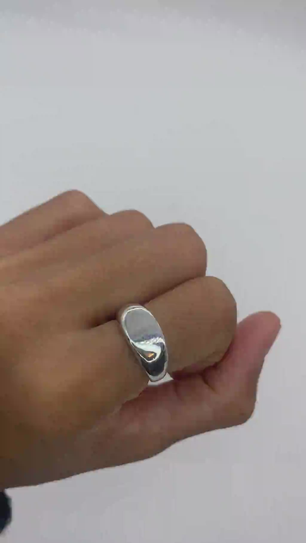 Side angle shot of a solid 925 sterling silver band ring worn on a hand for a natural lifestyle look.