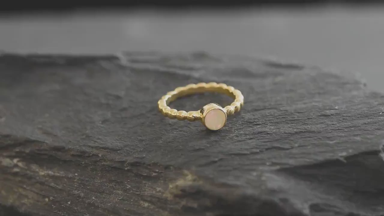 Yellow Fire Opal Bubble Band Ring in sterling silver with bezel set round cut, showcasing flashes of fire colors in a tennis band design for an elegant jewelry style. This durable and timeless piece is a meaningful October birthstone gift idea, symbolizing passion and inspiration. Ideal for birthdays, weddings, anniversaries, and evening occasions where a touch of unique brilliance is desired.