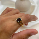 Natural Garnet January birthstone ring set in 18k yellow gold vermeil over solid 925 sterling silver, worn in an index finger for size reference. Red solitaire gemstone ring promotes energy, passion, and safety in travel. Often associated with love and commitment. Perfect for special occasions, and ideal birthday present