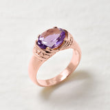 Rose gold ring featuring 10x8mm diamond cut natural amethyst with polished band