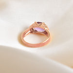 back angled view of rose gold ring with natural amethyst gemstone and diamond cut clarity
