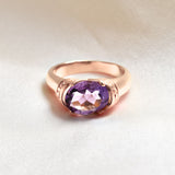 Close-up front view of rose gold amethyst ring highlighting diamond cut natural gemstone