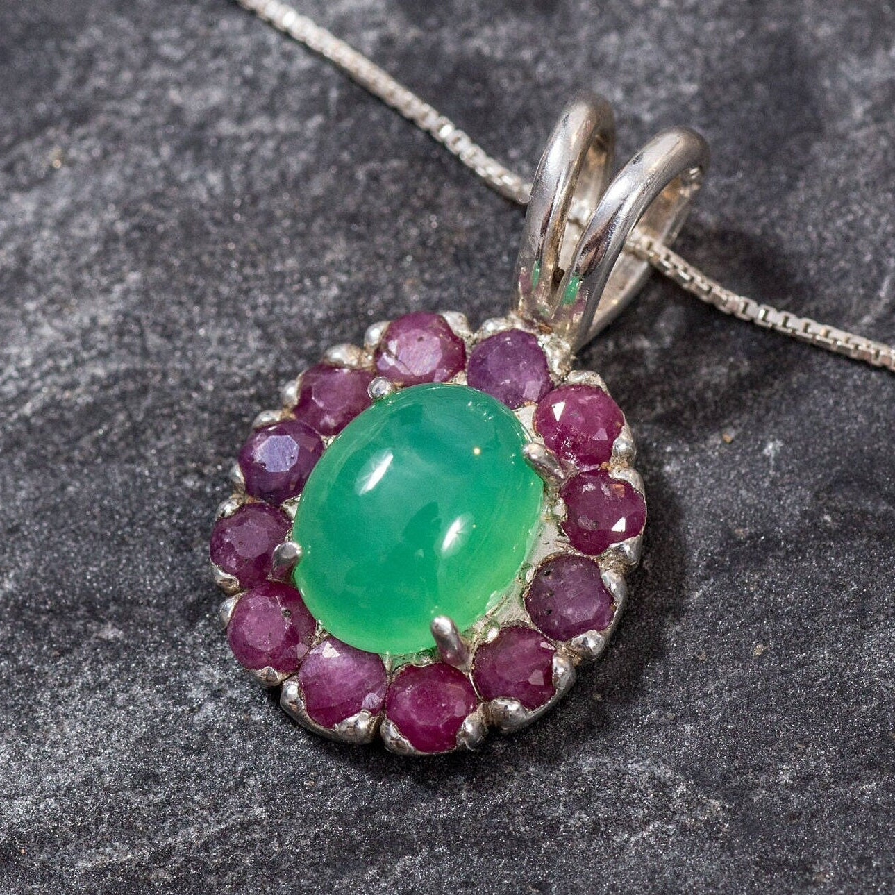 Deep pink Ruby halo around a Natural Chrysoprase center stone set in solid silver, adds charm and emotional grounding to any jewelry collection.