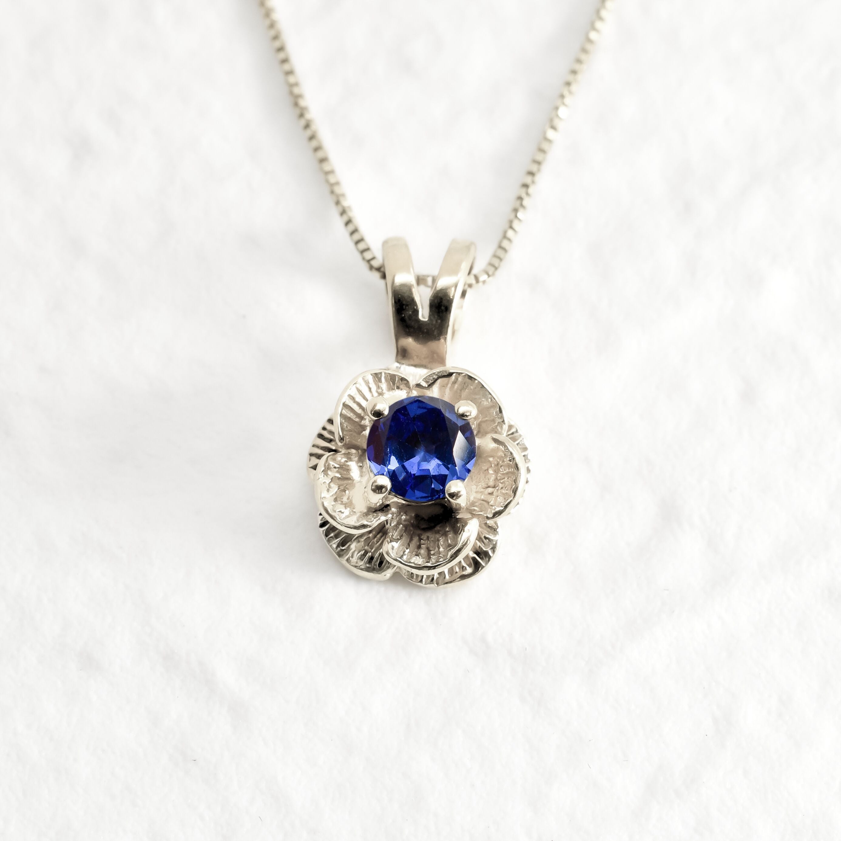 Tanzanite Flower Necklace set in Solid 925 Sterling Silver, in a round cut, stunning blue color, and prong setting. December birthstone pendant that promotes spiritual awakening, ideal for everyday wear, and for casual and chic style