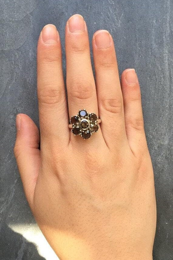 Floral Smoky Topaz ring styled on index finger, shown under sunlight to emphasize brilliance — matches well with summer dresses and neutral tones