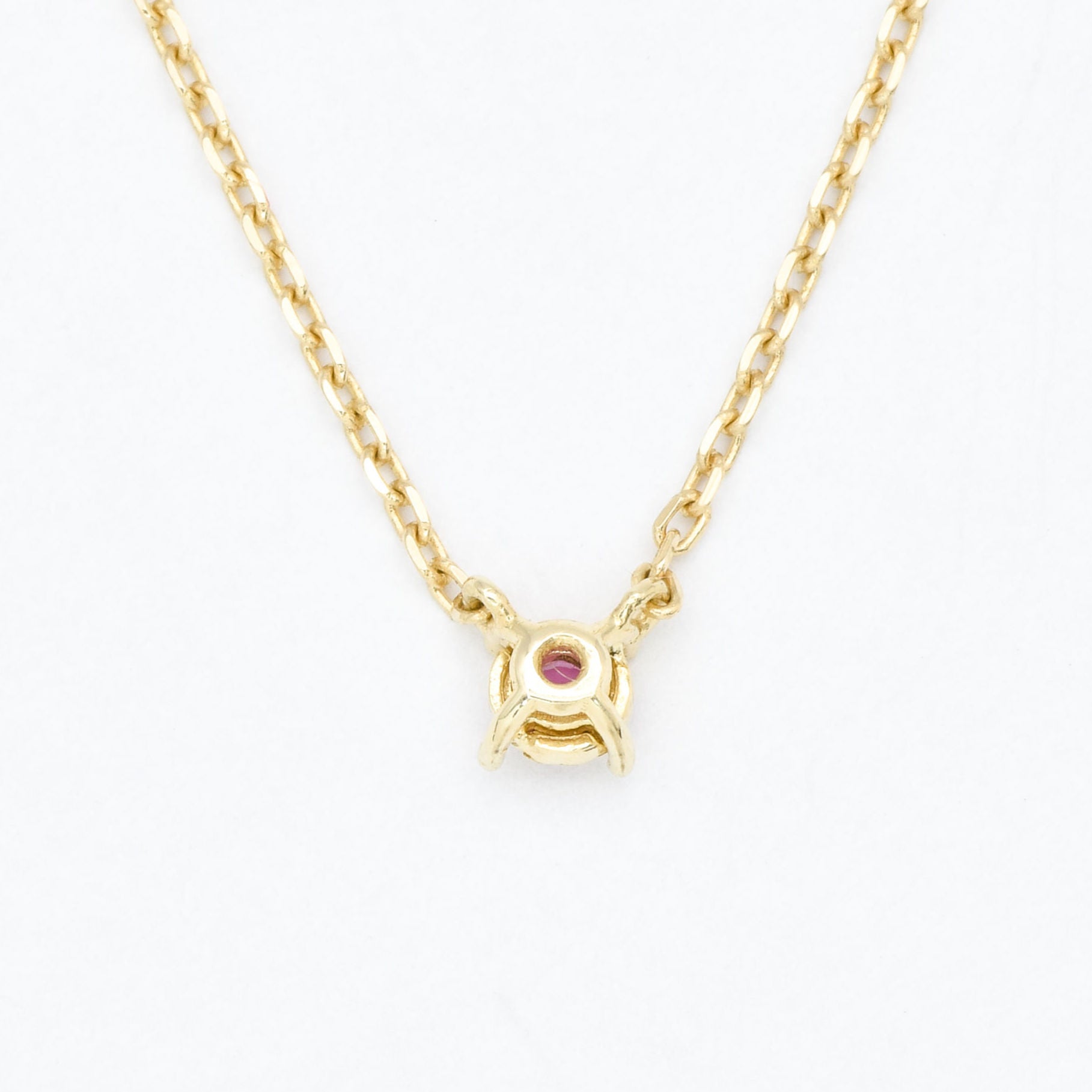 Solid 14k Yellow Gold necklace set with Natural Ruby July birthstone, in a dainty round cut, and prong setting. A perfect necklace gift idea for anniversaries, and july birthdays.