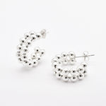 Front view of solid 925 sterling silver beaded hoop earrings on white background