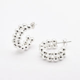 Front view of solid 925 sterling silver beaded hoop earrings on white background