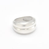Side angle view of a solid 925 sterling silver ring, highlighting its domed, polished band.