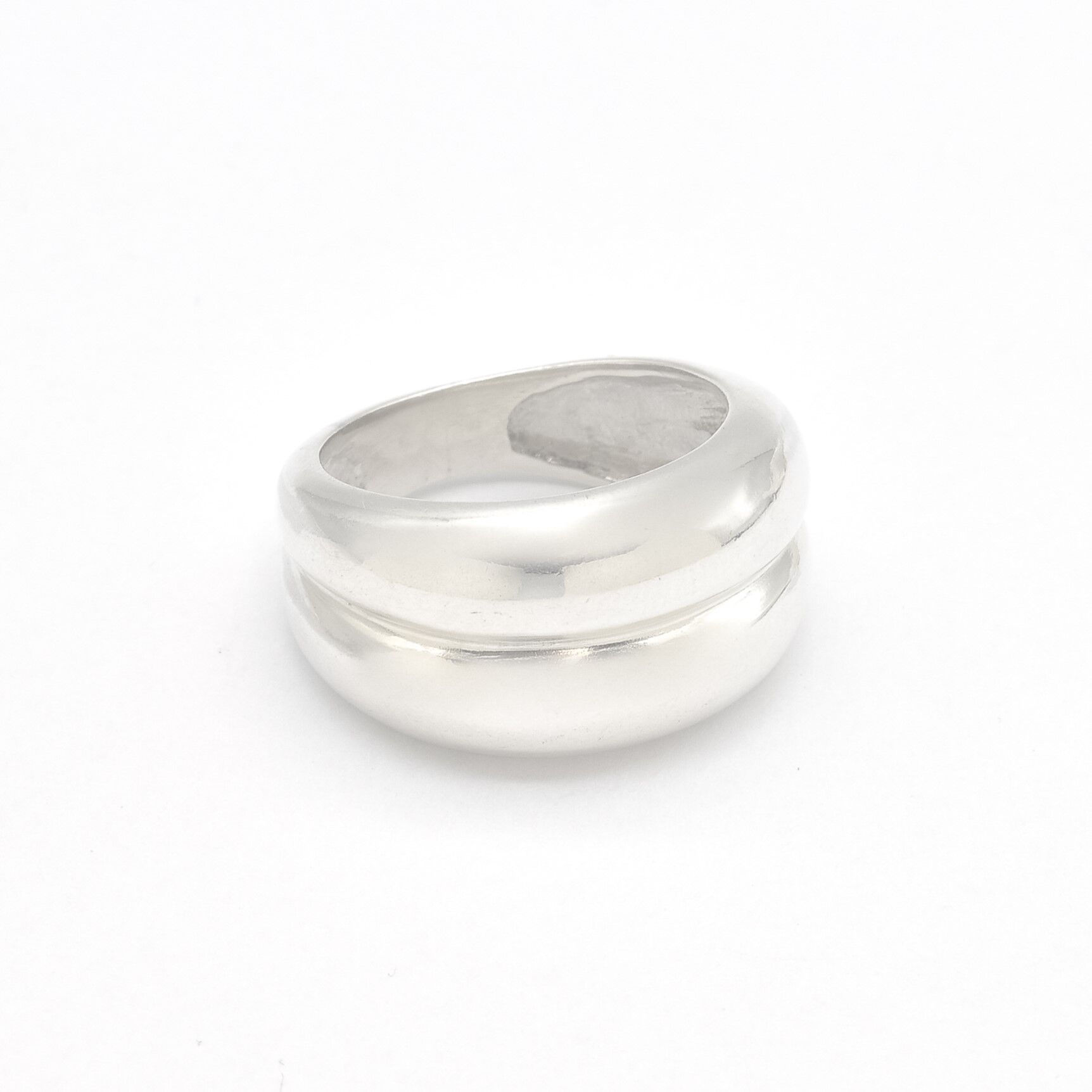 Side angle view of a solid 925 sterling silver ring, highlighting its domed, polished band.