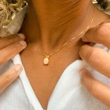 Woman wearing small Natural Opal necklace set in 18k gold vermeil over solid 925 sterling silver, in oval cut, and prong setting. October birthstone necklace perfectly worn for minimalist styles