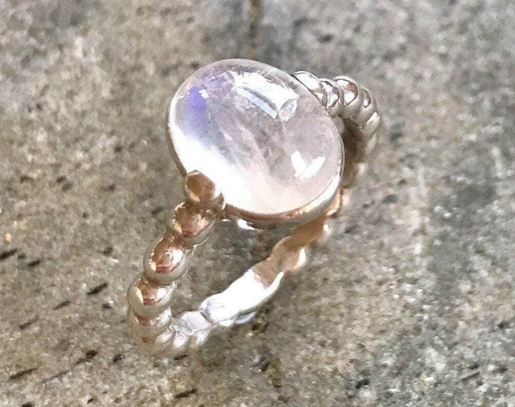 Sterling silver Moonstone ring captured in soft natural lighting, radiates harmony and peace, fits slow living or nature-inspired events.