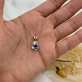 Tanzanite December Birthstone Pendant set in solid 925 sterling silver, resting in an open palm for size reference. A meaningful flower inspired necklace gift for her.