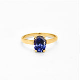 Tanzanite gold ring with 8x6mm deep blue diamond cut gemstone on polished gold band