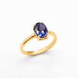 Front view of tanzanite gold ring highlighting diamond cut gemstone and smooth gold band