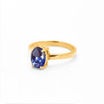 Side profile of tanzanite gold ring showing gemstone setting and polished gold band